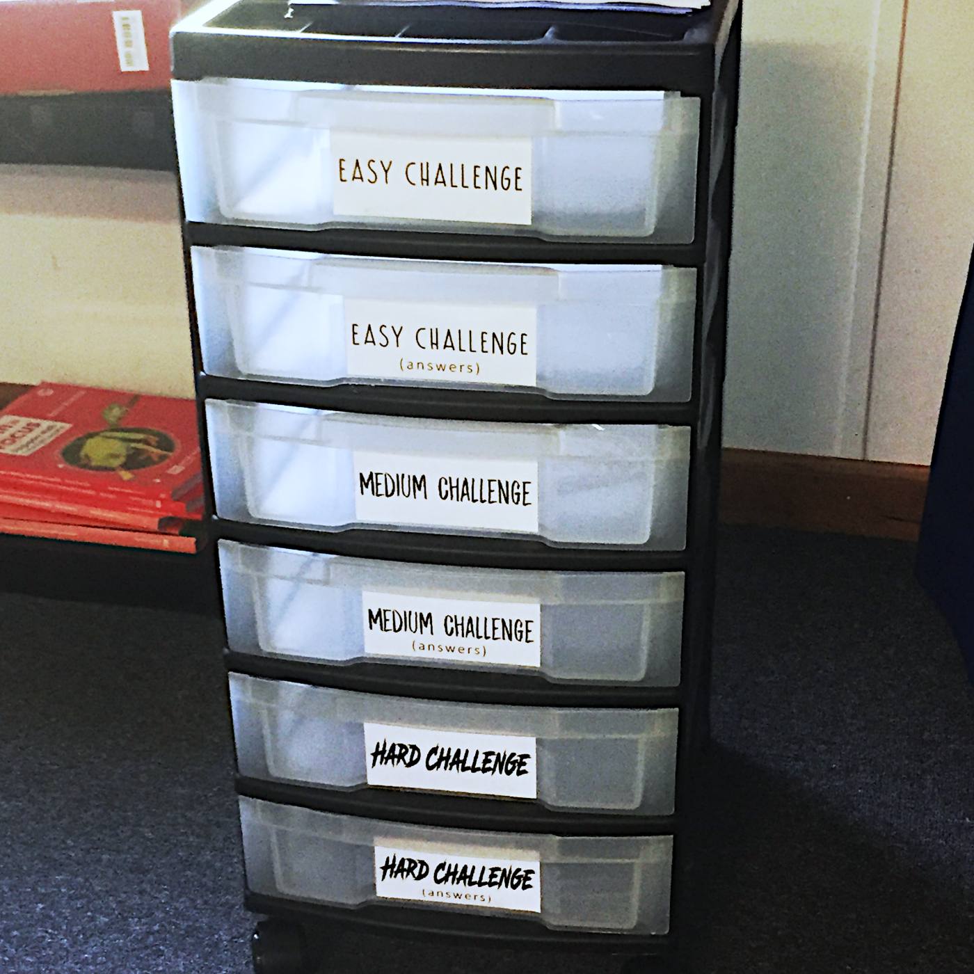 A rolling six-drawer cart labeled Easy, Medium, and Hard Challenge, each drawer followed by a matching answers drawer.